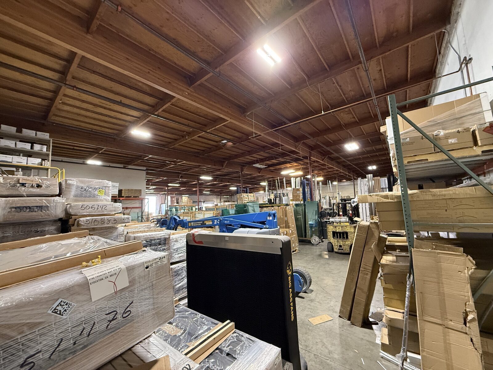 Glass shop inventory area with new LED lighting installed across the ceiling — Cyber Electric LLC