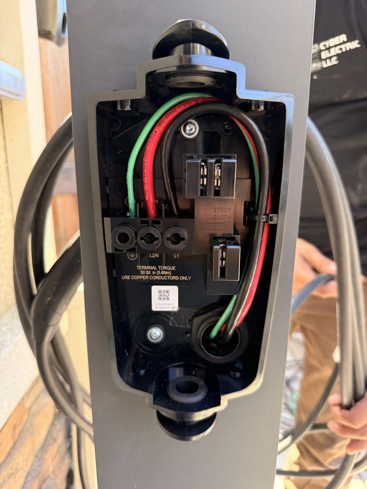 Tesla Wall Connector wiring termination — L1, L2/N, ground conductors torqued to 50 lb-in spec — Cyber Electric LLC