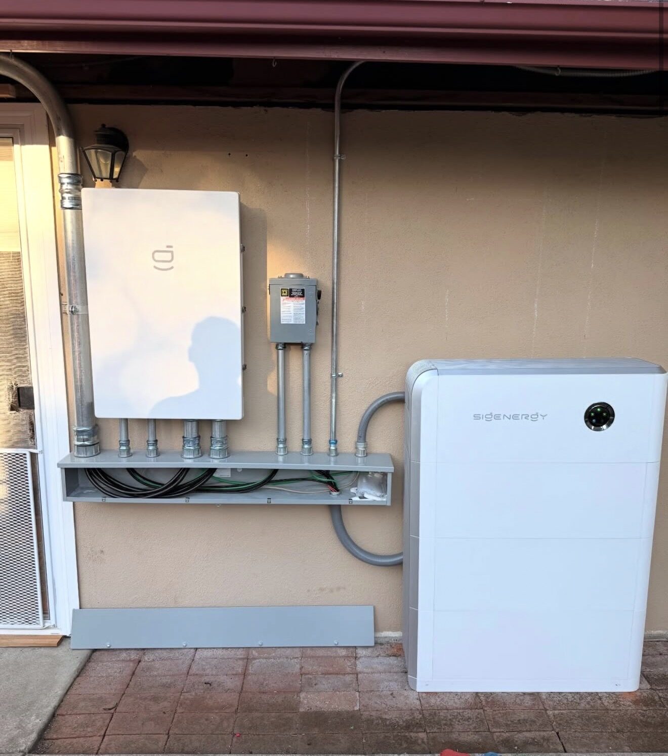SigenStor battery unit and Sigen Load Hub mounted on exterior wall — Cyber Electric LLC