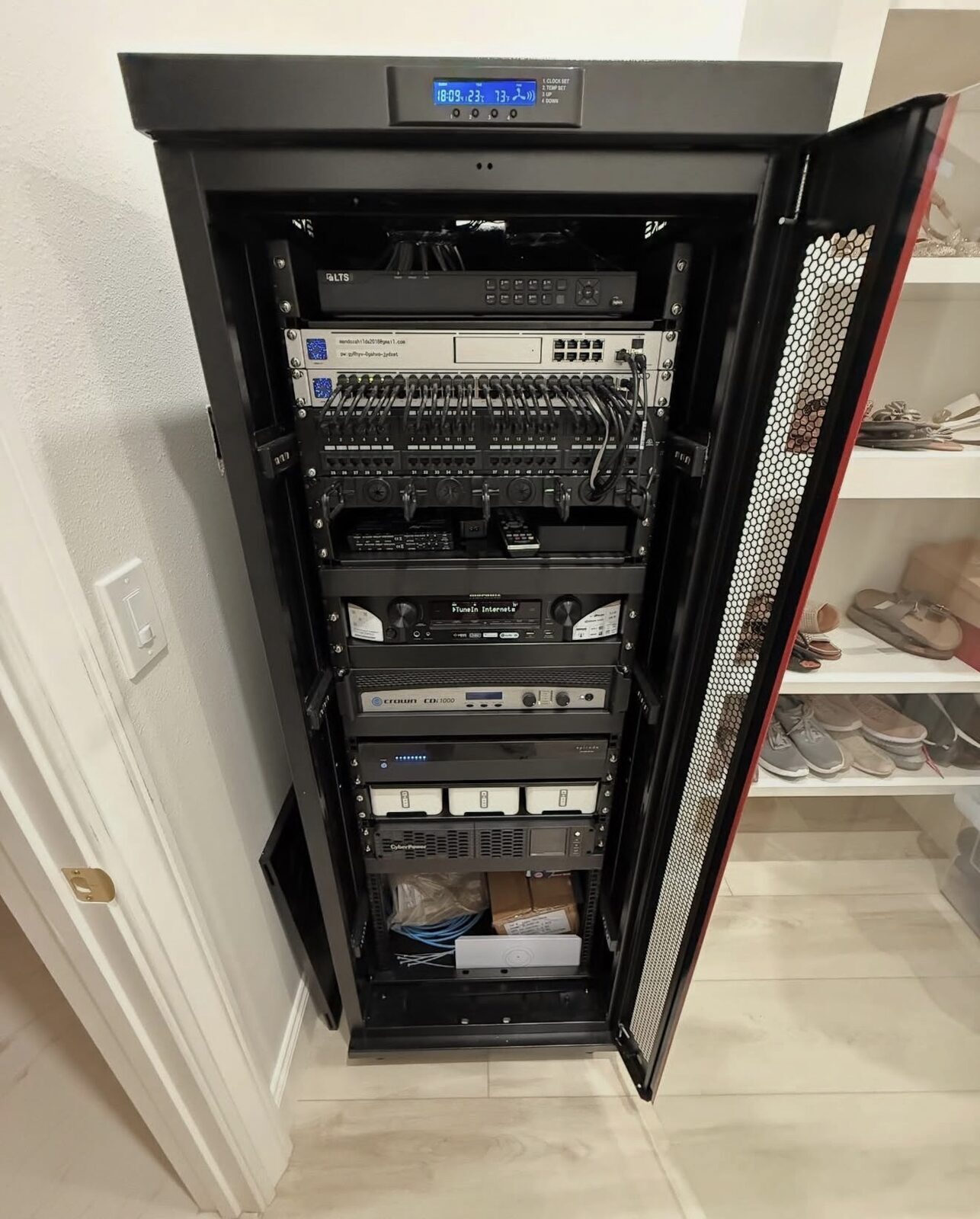 Custom smart home network rack with Ubiquiti switch, NVR, home theater AVR, Sonos, Starlink, and battery backup — Cyber Electric LLC