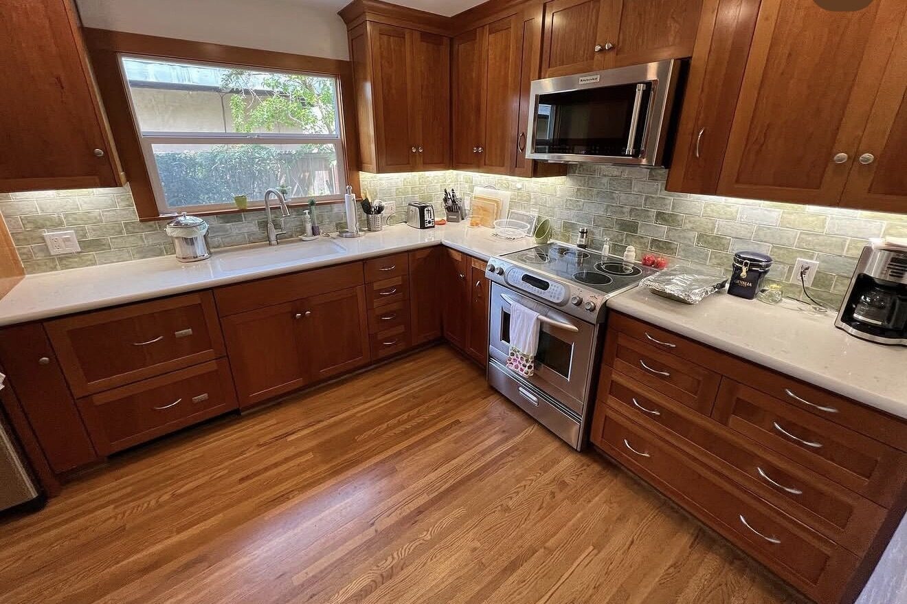 Kitchen with new recessed ceiling lights and under-cabinet LED lighting — dark wood cabinets, stainless appliances — Cyber Electric LLC, Modesto CA